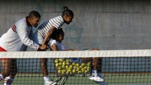 Will Smith as Richard Williams, training with his daughters Venus and Serena Williams.