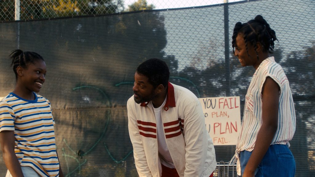 Will Smith as Richard Williams, training with his daughters Venus and Serena Williams.